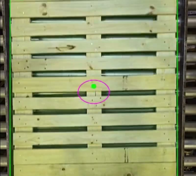 Overhead inspection camera frame of a new 48 by 40 GMA pallet on a roller conveyor